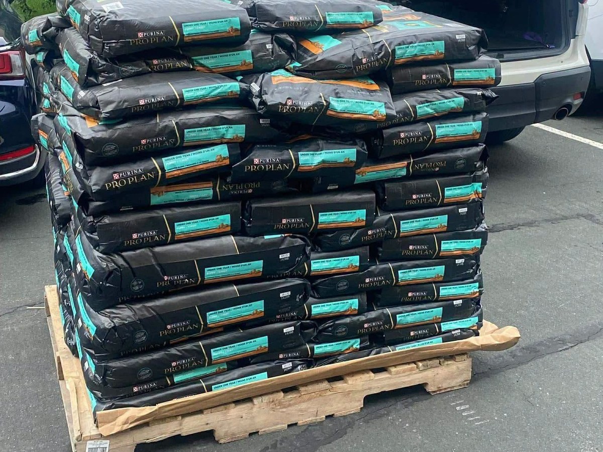 A pallet of donated Purina dog food being loaded for delivery
